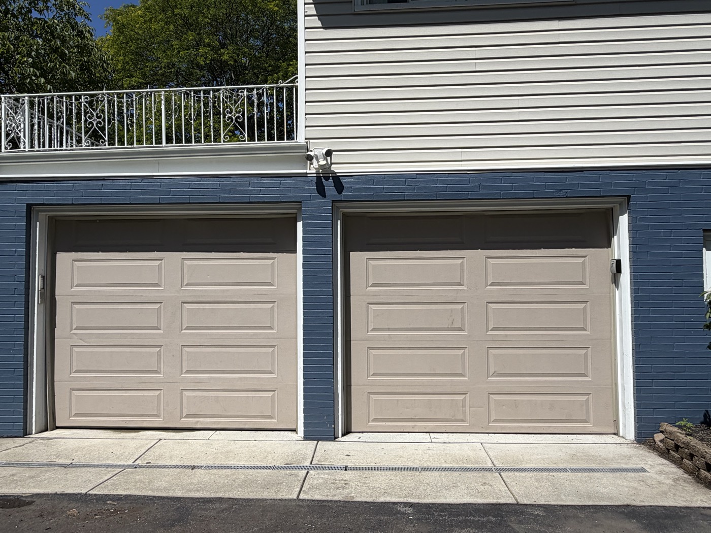 The same garage driveway after pressure washing, clean and bright